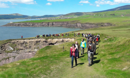 People walking along a cliff